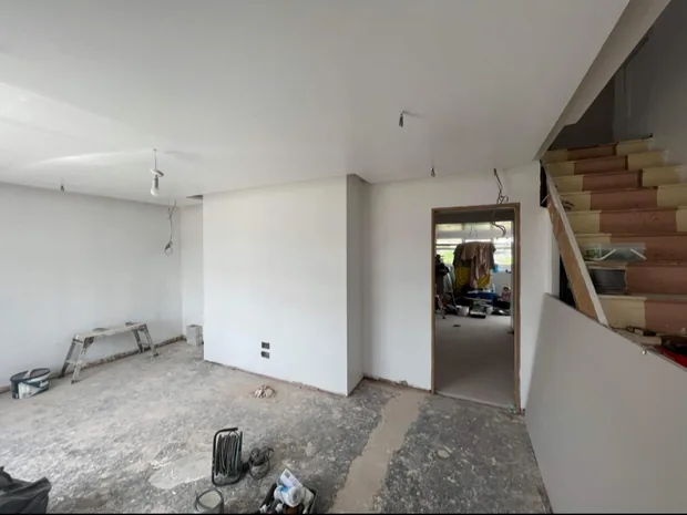 Interior of a Caerphilly house part-way through a full renovation, walls plastered and the through-room opened up