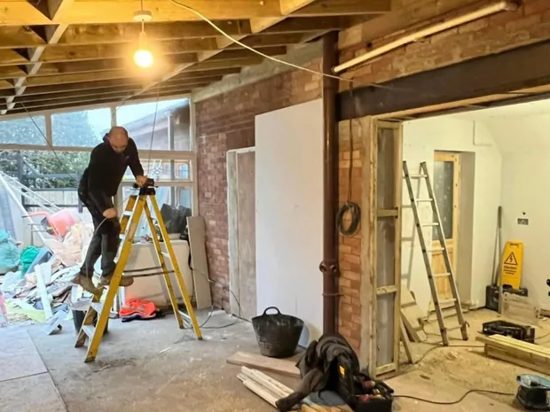 Working at roof level on exposed timbers during a roof and structural job at a Caerphilly property